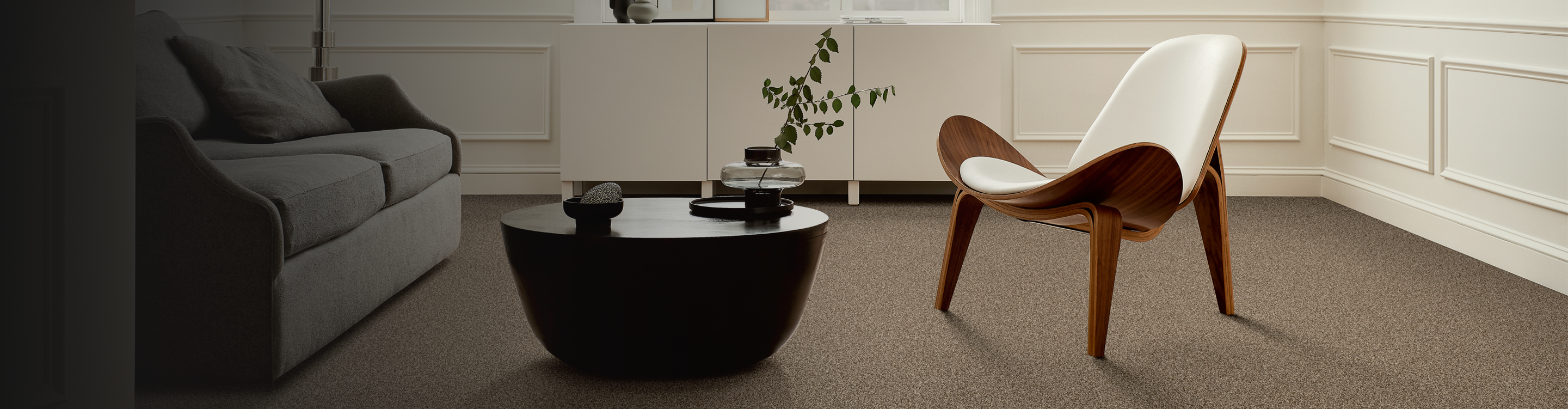 Living room with brown carpet and modern accent chair