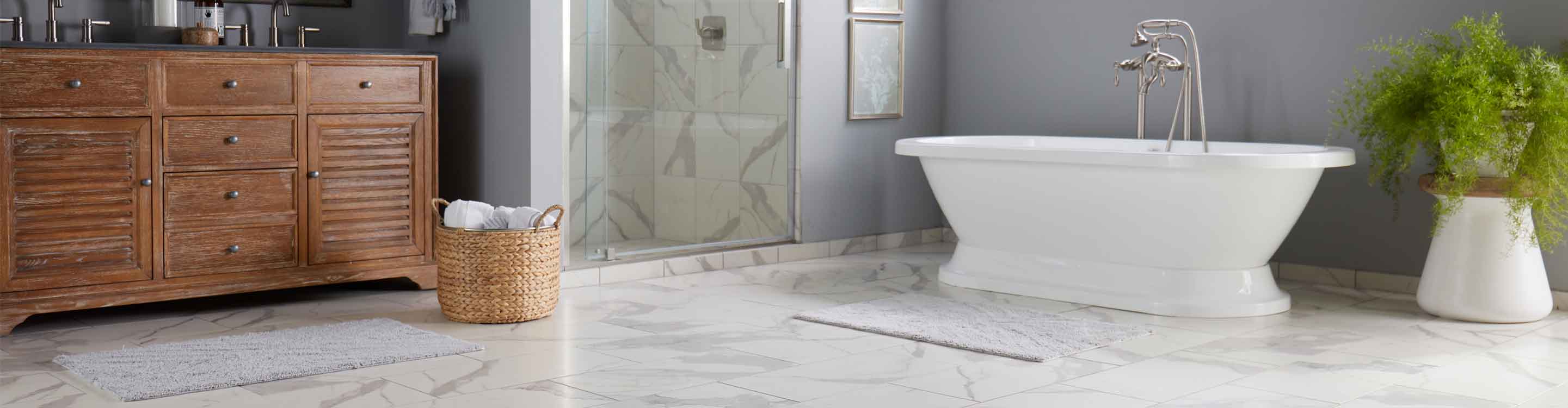 Bathroom with marble look tile flooring in South Dakota, and freestanding bathtub