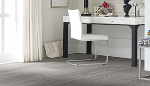 gray wood look LVT floor underneath a glamorous white desk